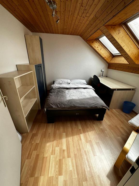 a bedroom with a bed and a desk in a attic at Sunny private Apartment in an amazing valley in Wila