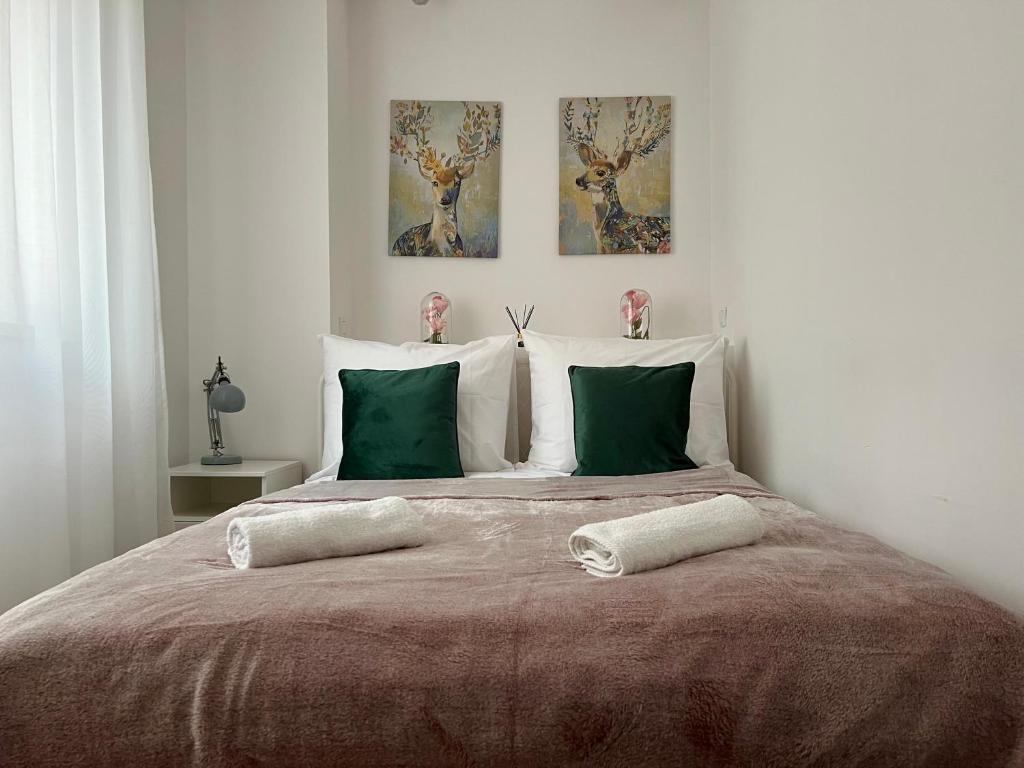 a bedroom with a large bed with two pillows at Melody Apartment in Krakow