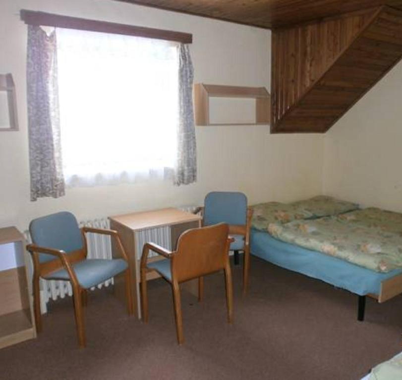 Postel nebo postele na pokoji v ubytování Horská chata Roubenka