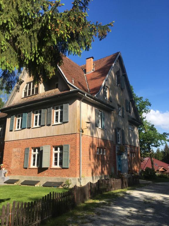 an old red brick house with a red roof at Widokówka in Łagów