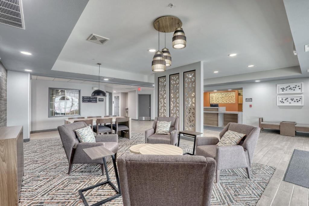 a waiting room with chairs and a table at Candlewood Suites Milwaukee Airport - Oak Creek, an IHG Hotel in Greendale