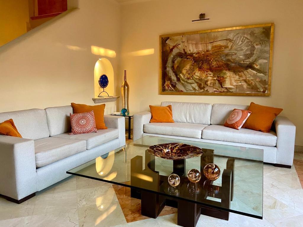 a living room with two couches and a coffee table at Villa Navarro: Marina Vallarta in Puerto Vallarta
