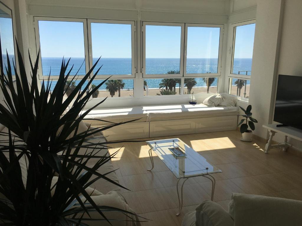 a living room with a view of the ocean at Ático Almería. Paseo marítimo Roquetas de Mar in Roquetas de Mar