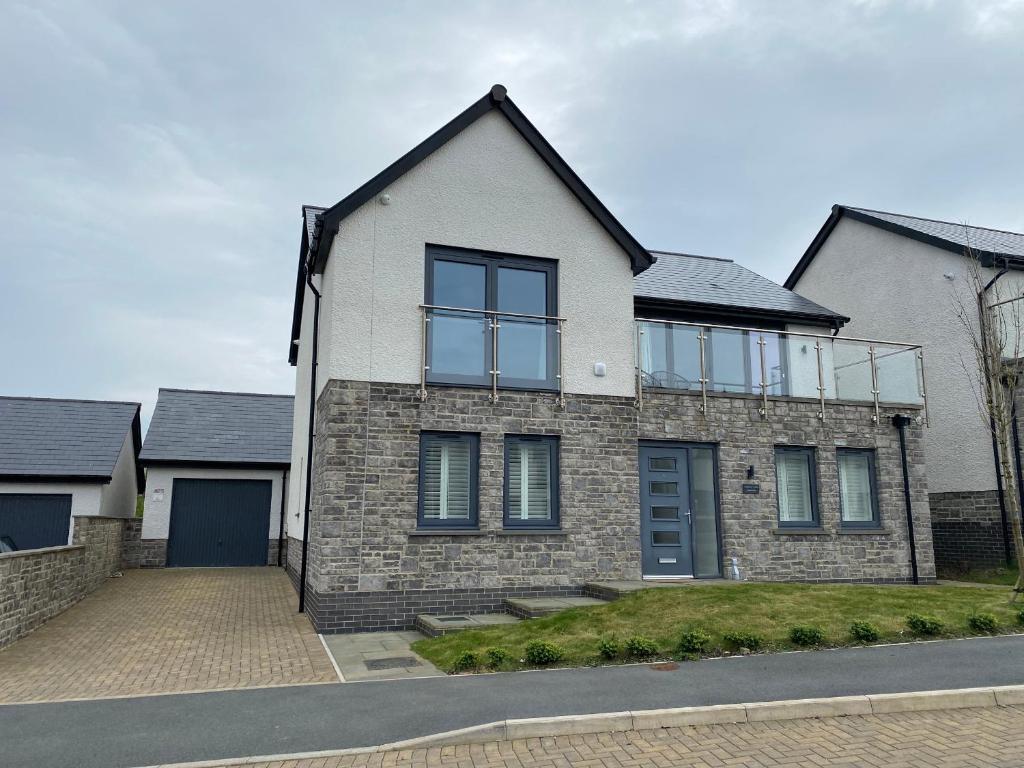 a large brick house with windows on a street at Galwad y Mor in Haverfordwest