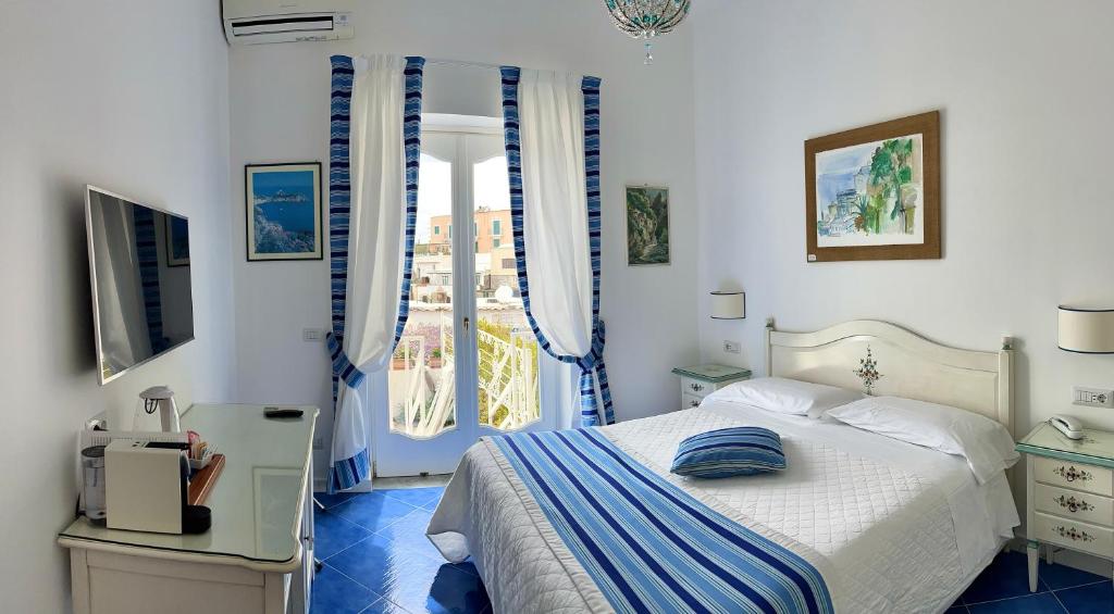 a bedroom with a bed and a window at Hotel Villa Delle Palme in Positano in Positano