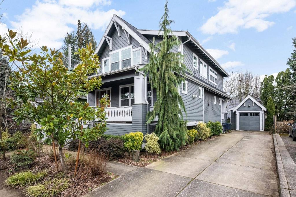 a grey house with a driveway at Waverly Place in Portland