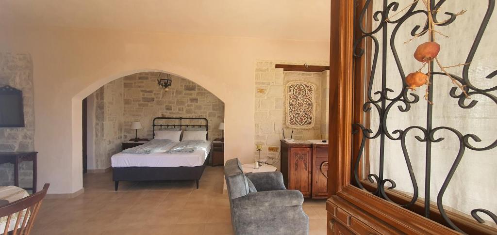 a bedroom with a bed and a chair in a room at Aelia Apartment III in Kamilari