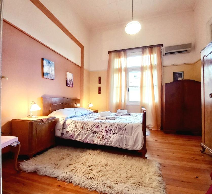 - une chambre avec un lit, une fenêtre et un tapis dans l'établissement Zeta's vintage garden house, à Sparte