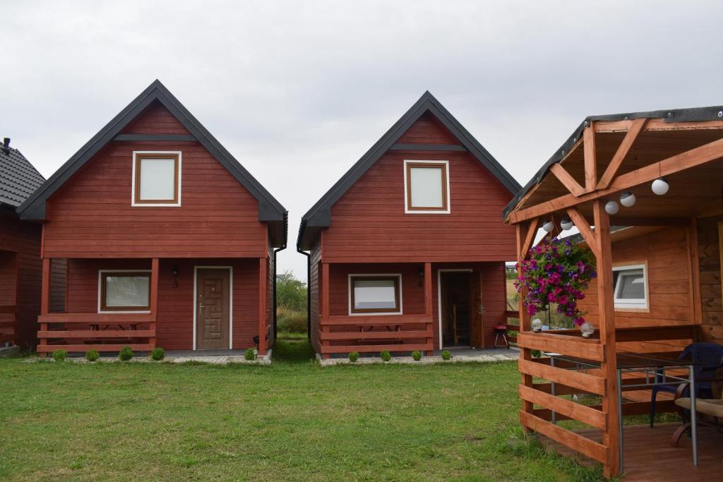 a group of three houses with a yard at Marco in Sarbinowo