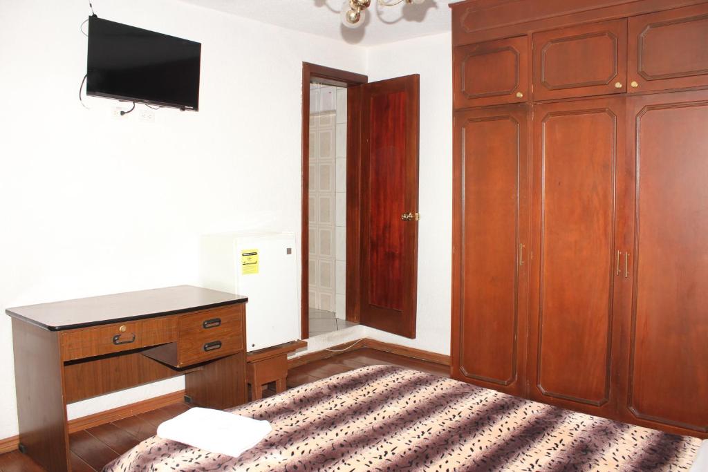 Postel nebo postele na pokoji v ubytování Hostal La Catolica