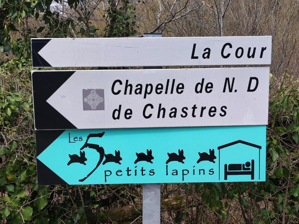 a street sign with bats on it in front at Les 5 Petits Lapins in Bar
