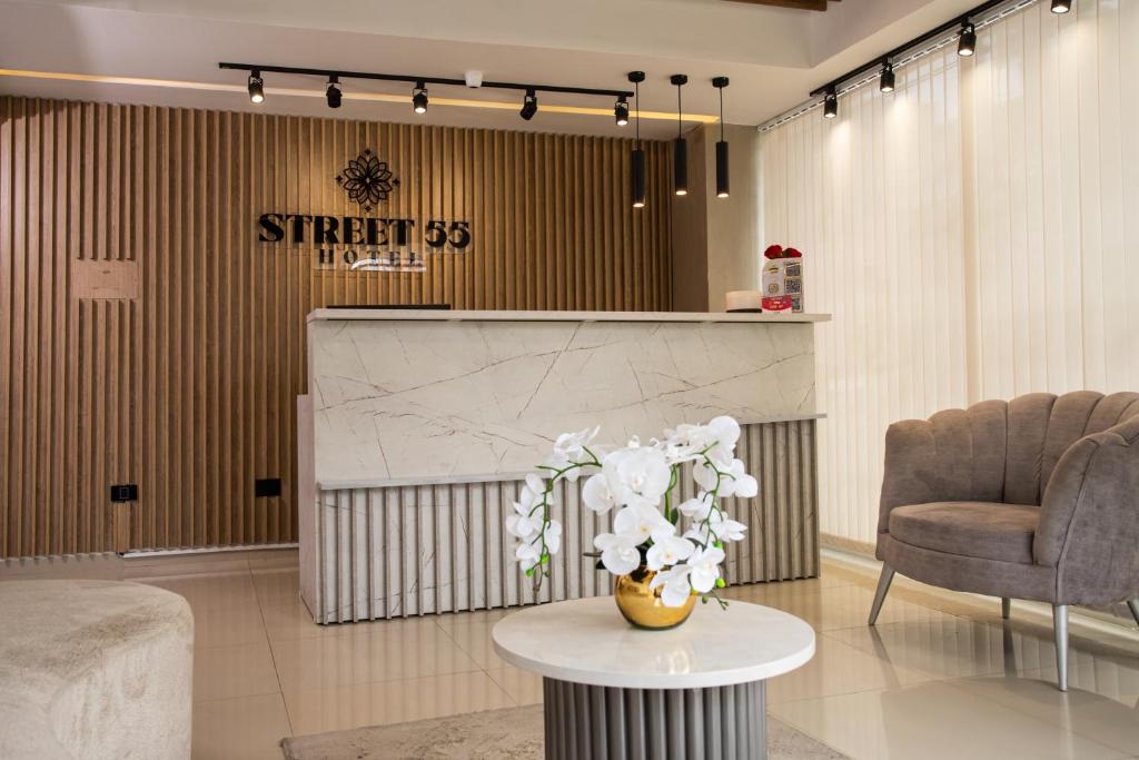 a lobby with a table and two chairs and a sign at Street 55 Hotel in Bucaramanga