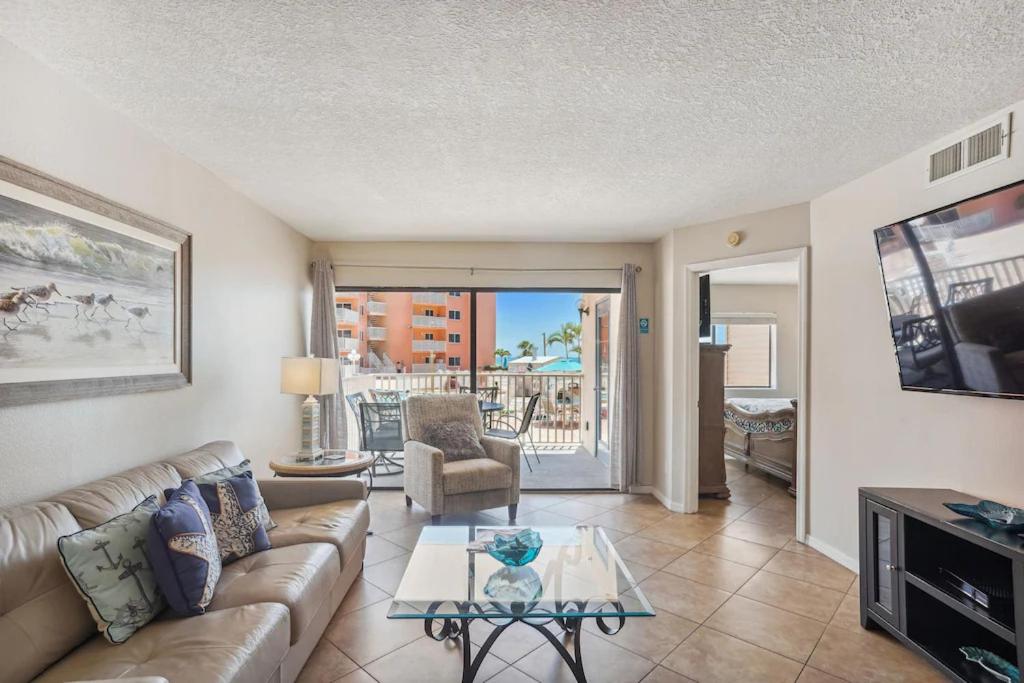 a living room with a couch and a table at Beach Palms- Unit 102 in Clearwater Beach