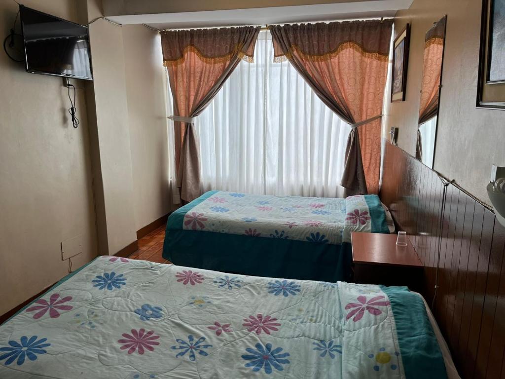 Postel nebo postele na pokoji v ubytování Hotel Cotopaxi