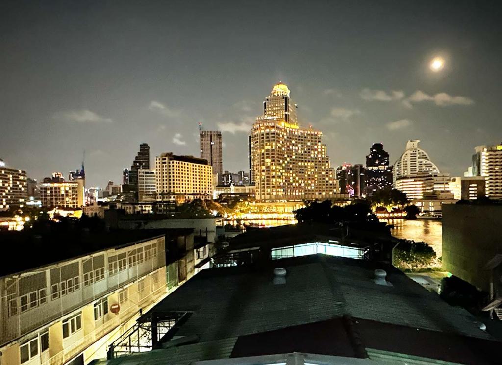 a view of a city skyline at night at River Home Bangkok in Bangkok