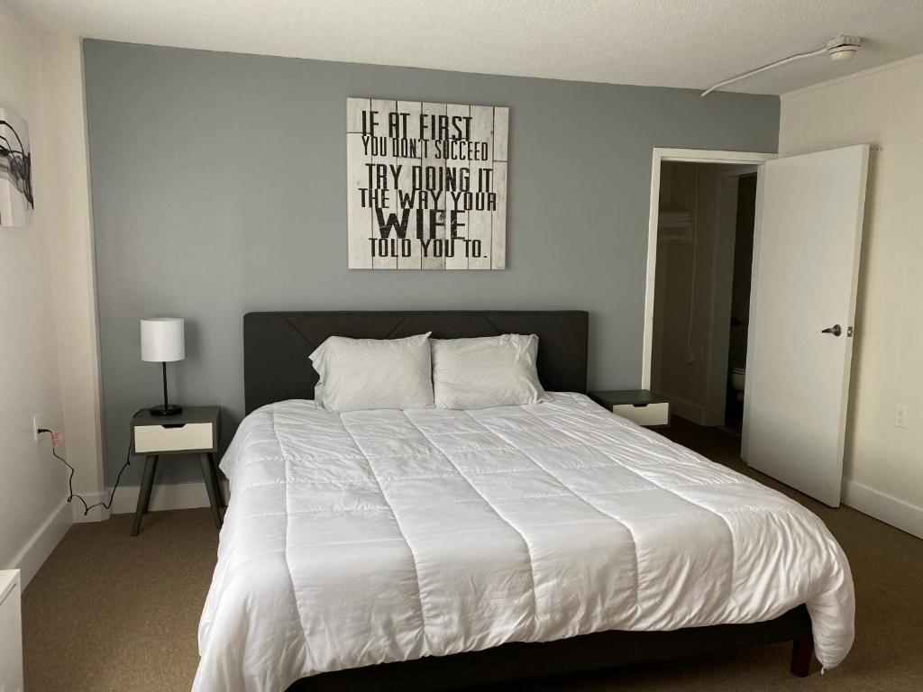 a bedroom with a bed with a poster on the wall at Quaint studio apartment in Gadsden, Al in Gadsden