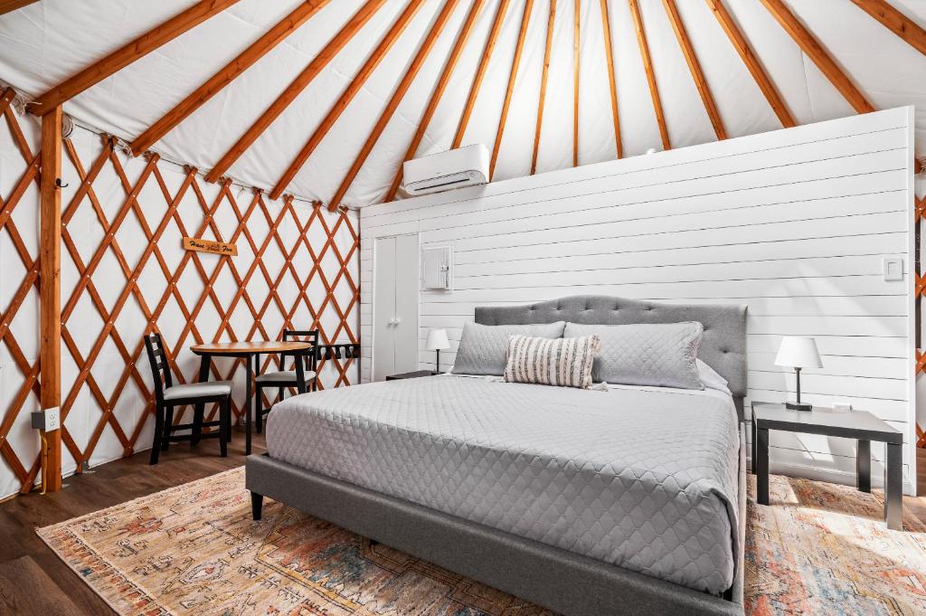 a bedroom with a bed and a table in a tent at OT 3515J Texas Yurt Haus Javelina in New Braunfels