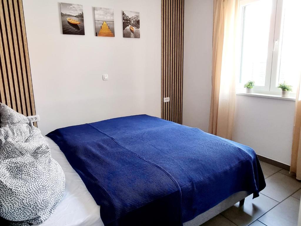 Postel nebo postele na pokoji v ubytování Apartments Žman