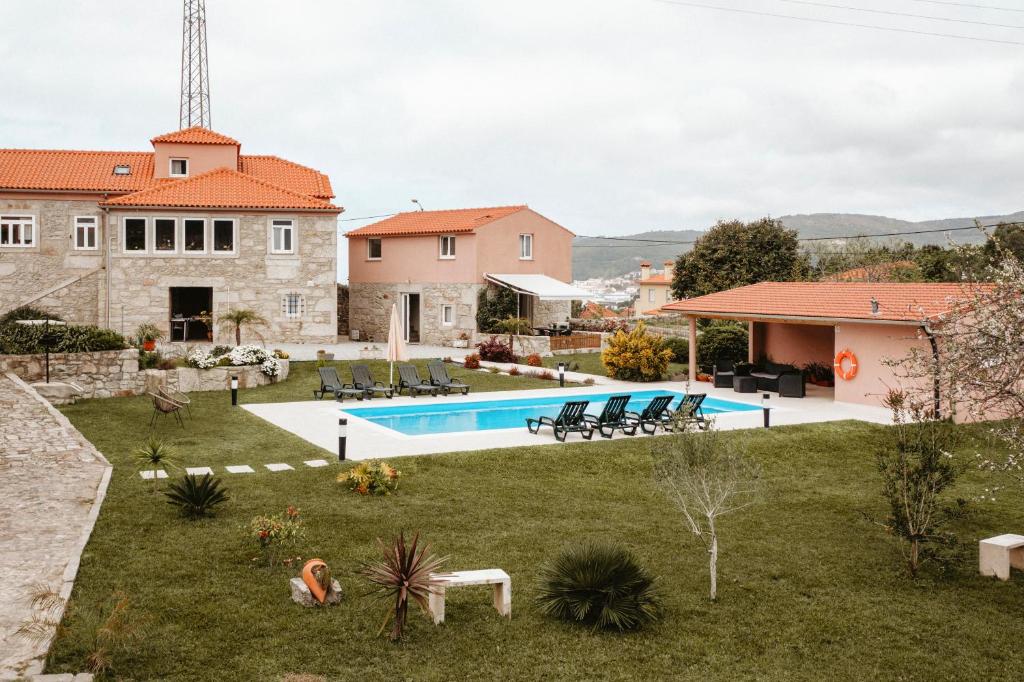 a house with a swimming pool in a yard at Forno House - O Lagar in Vila Praia de Âncora