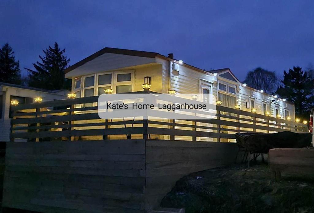 a house with a fence with a sign on it at Kates Home Lagganhouse Woodland Way 19 in Ballantrae