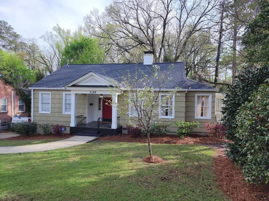 a small house with a tree in the yard at Historic Ingleside Avenue Charm in Macon