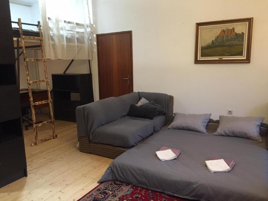 a living room with a bed and a couch at Apartment Dedo in Koper