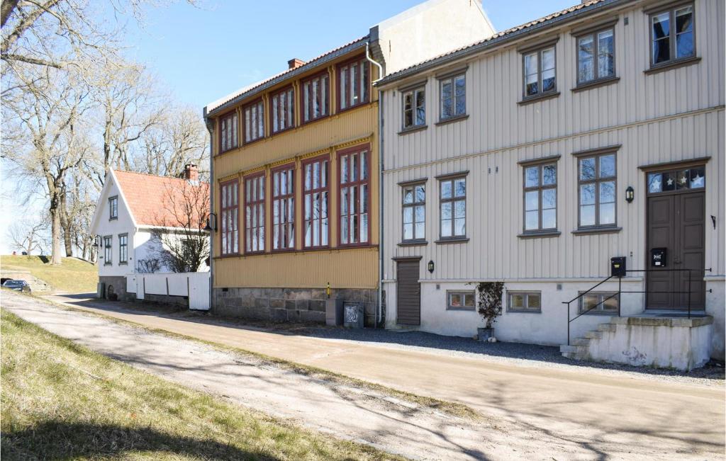 a large yellow and white building next to a street at 3 Bedroom Beautiful Apartment In Gamle Fredrikstad in Vaterland
