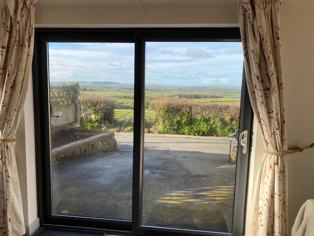 a window with a view of the countryside outside at Stonecroft Cwtch in Haverfordwest