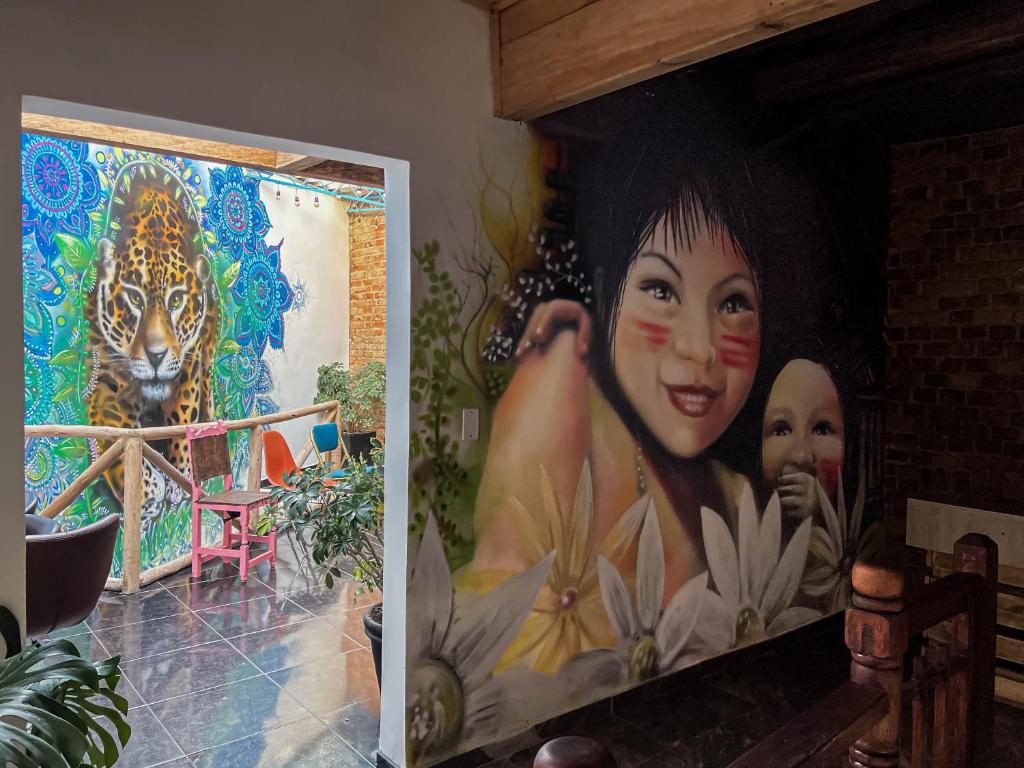 a painting of a woman and a tiger in a room at Ancestral Hostel in Bogotá