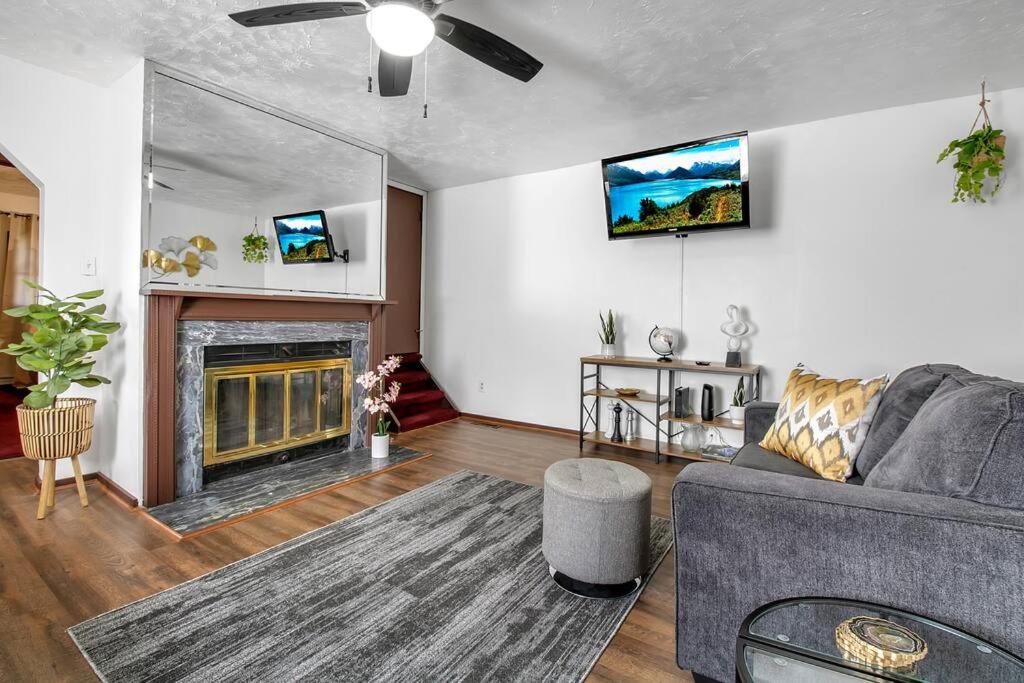 a living room with a couch and a fireplace at Welcome to our Cozy Krib in Buffalo