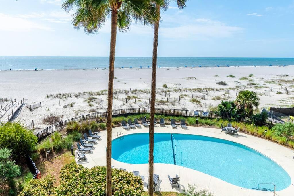 an overhead view of a pool and the beach at Seascape 315 - Oceanfront Condo Overlooking Pool in Isle of Palms