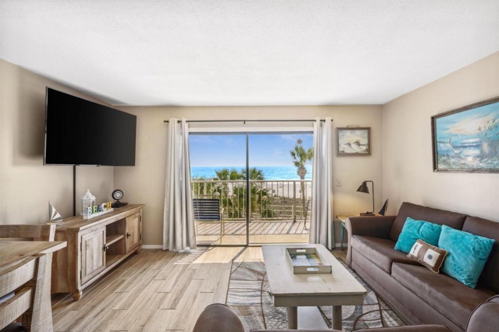 a living room with a couch and a view of the ocean at The Summit 307 in Panama City Beach