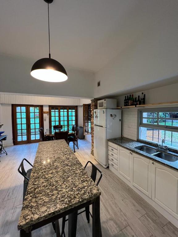 a large kitchen with a table and a dining room at Casa 9 de julio in Tandil