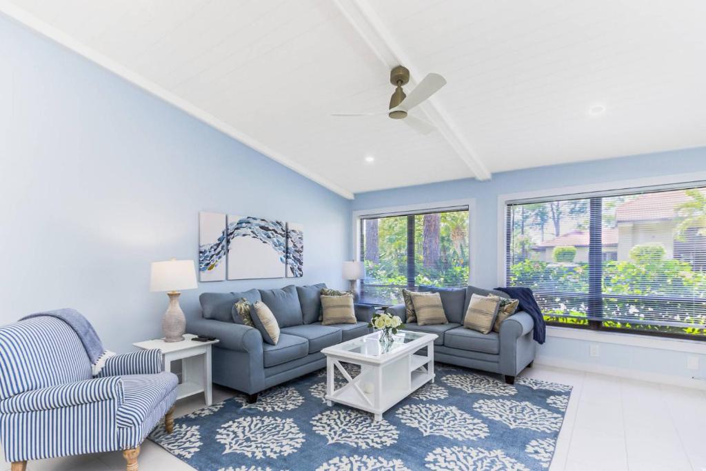 a living room with two couches and two chairs at Yellow Pine Duplex Close to Pool & Tennis in Sarasota