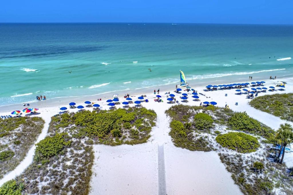 an aerial view of a beach with umbrellas and the ocean at Siesta Sands Beach Resort Gulf View in Sarasota