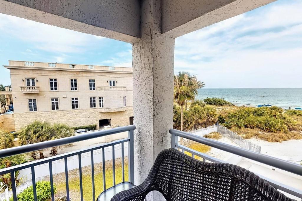 a balcony with a view of a building and the ocean at Siesta Sands Beach Resort Gulf View in Sarasota