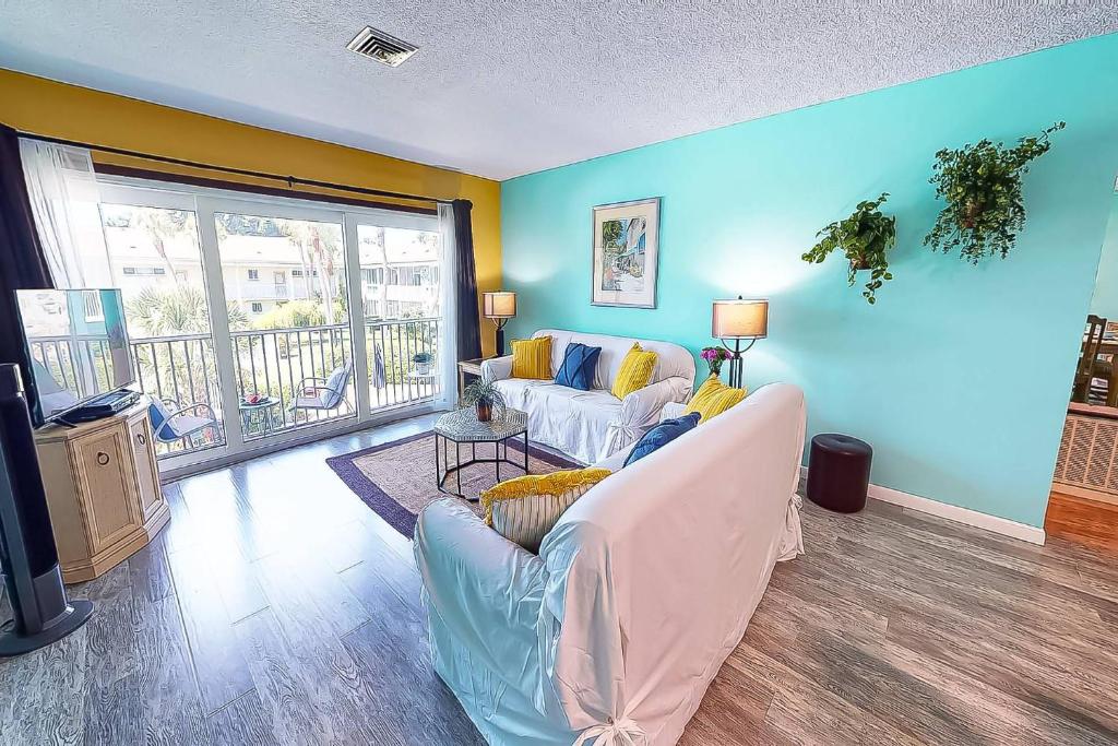 a living room with two couches and a large window at Kingston Arms On Lido Key, 1BR in Sarasota