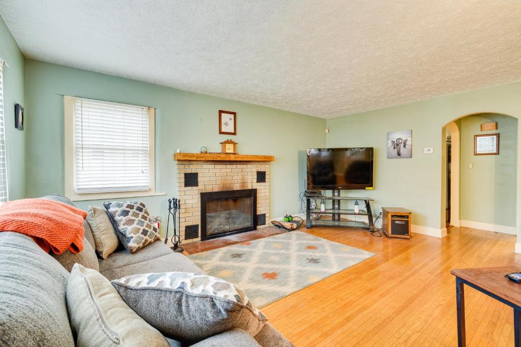 a living room with a couch and a fireplace at Sodus Point Vacation Rental Steps to Lake Ontario in Sodus