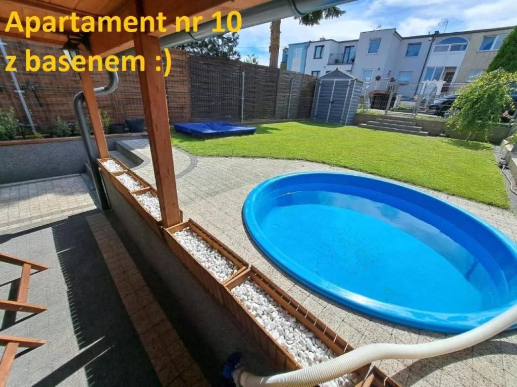 a swimming pool with a blue tub in a yard at Twoja Przystań in Władysławowo