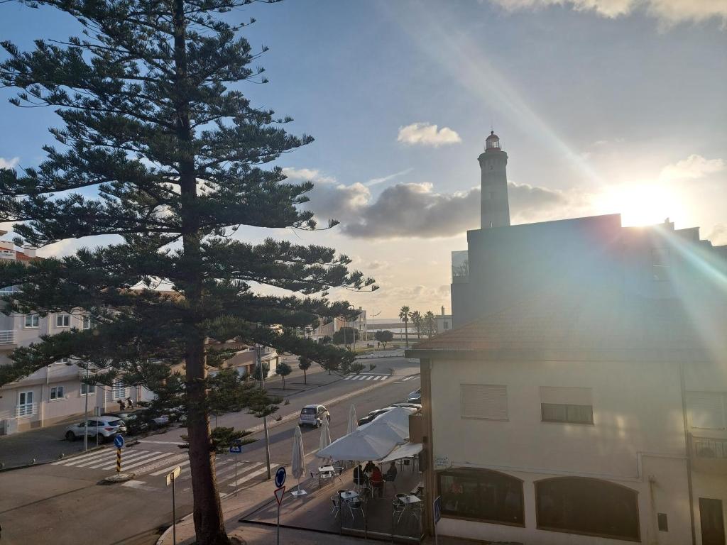 a light house with a lighthouse on a city street at Apartamento Mar e Sol in Gafanha da Nazaré