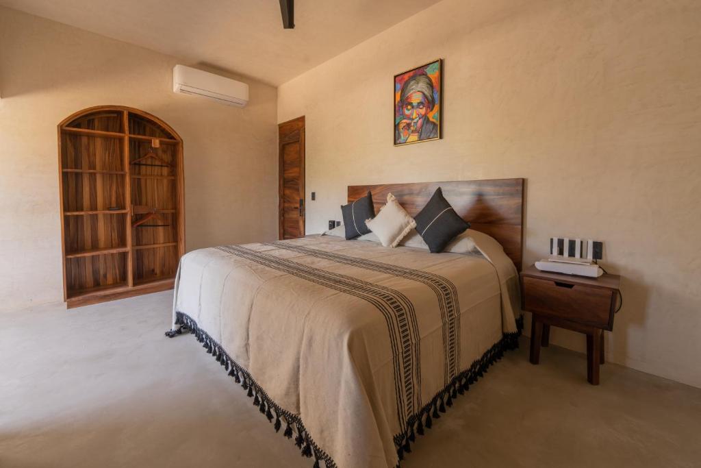 1 dormitorio con 1 cama y 1 mesa con mesita de noche en Casa Mava en Brisas de Zicatela