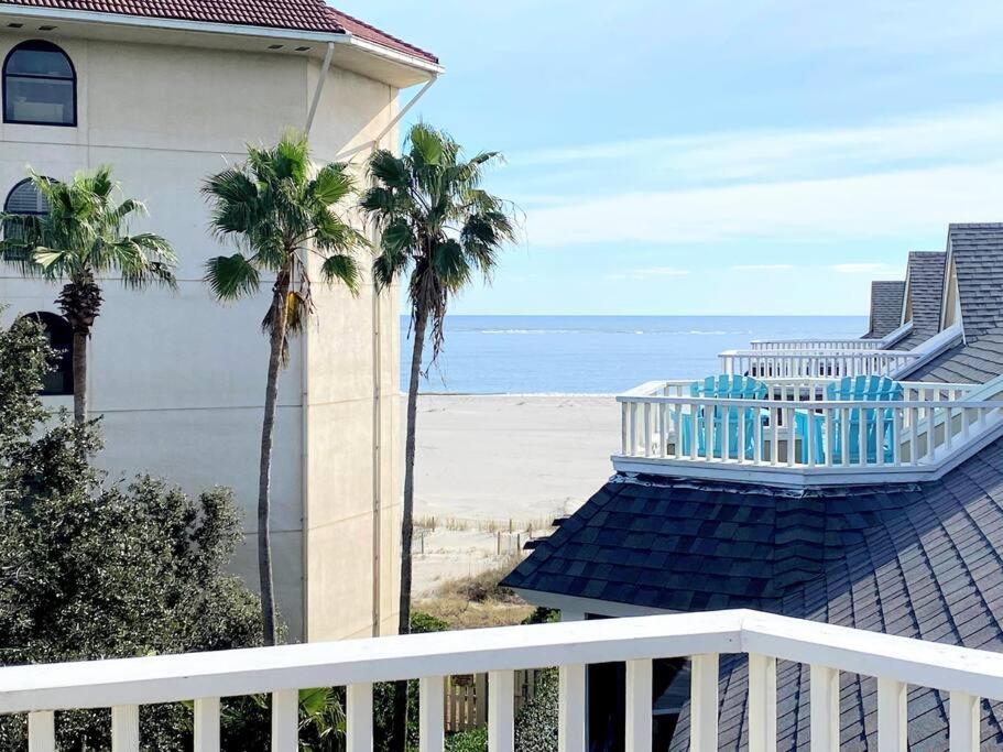 a balcony of a house with palm trees and the beach at Port O' Call G304 - Modern Oceanview! Atlantic Escape! in Isle of Palms
