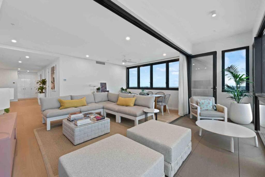 a living room with a couch and a table at New 3 Bed Penthouse Resort style complex in Brisbane
