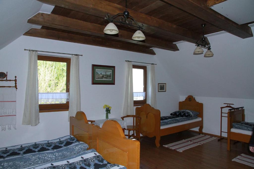 a living room with two beds and a window at Árpád Ház in Alsónána