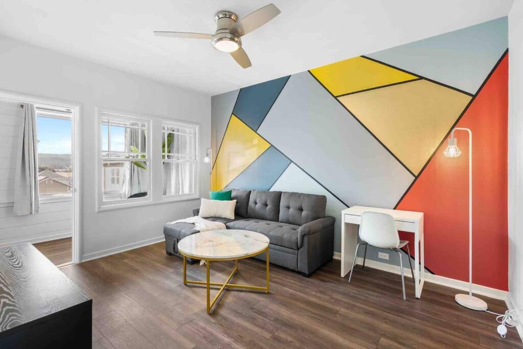 a living room with a couch and a painting on the wall at New 2BR 1BA Retreat With Modern Design in South San Francisco