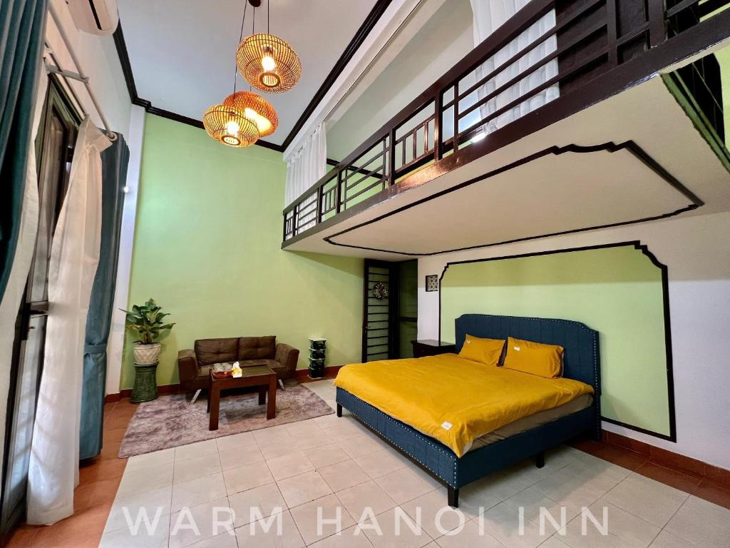 a bedroom with a yellow bed and a staircase at Warm Hanoi, near Hoankiem Lake, 2Brs, Old Quarter in Hanoi
