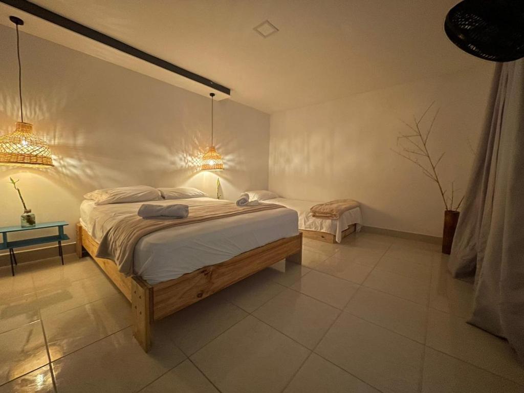 Postel nebo postele na pokoji v ubytování Hotel Neblina Calima
