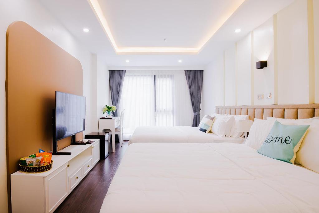 Postel nebo postele na pokoji v ubytování Royal Lotus Hotel