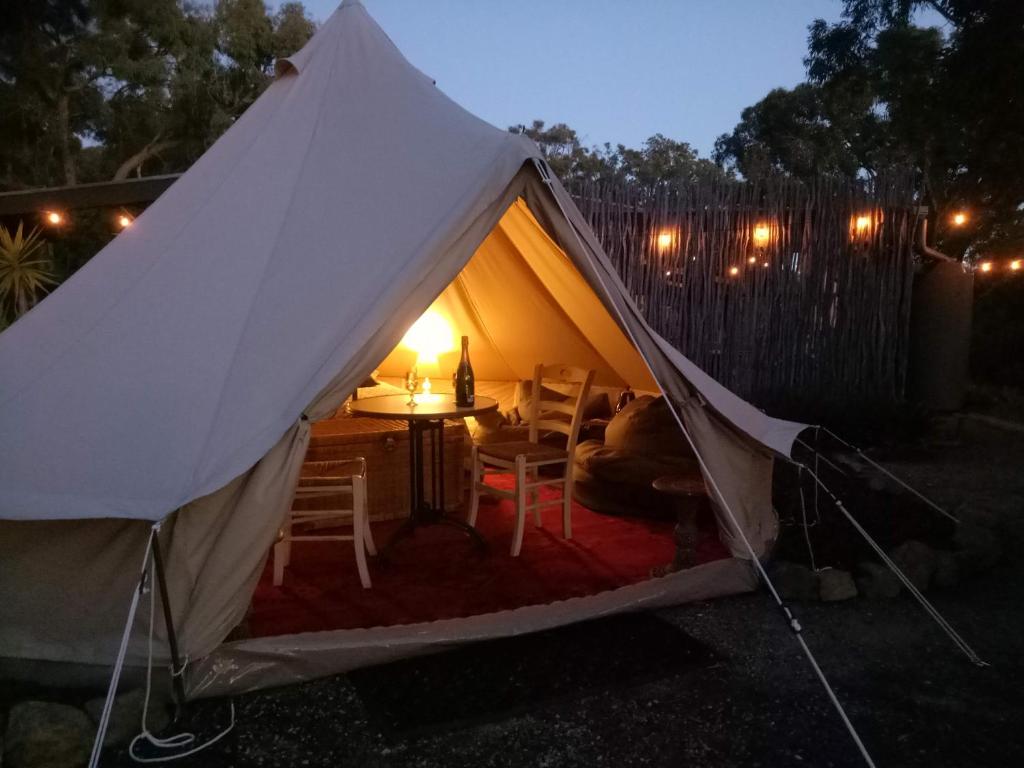 a tent with a table and chairs in a yard at Macedon Ranges Glamping in Macedon
