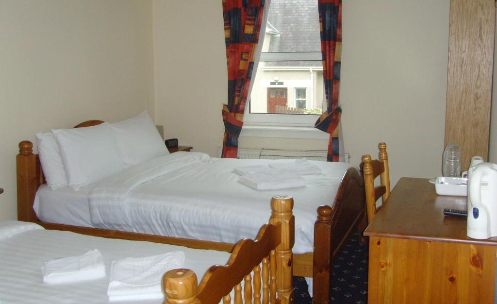 Postel nebo postele na pokoji v ubytování Twin Lions Hotel